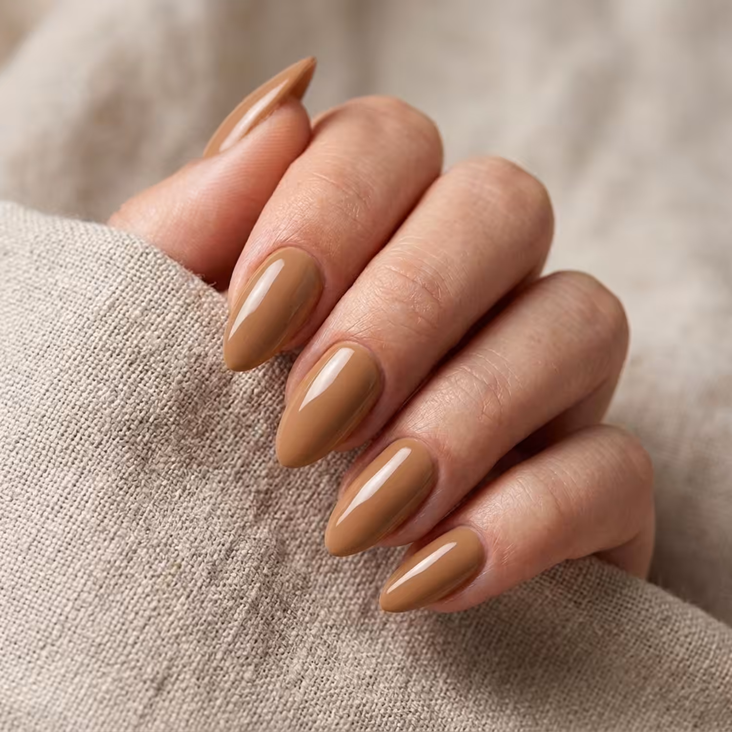 Mão com unhas pintadas com o Esmalte em Gel Cacau Absoluto, da Linha Essência Natural