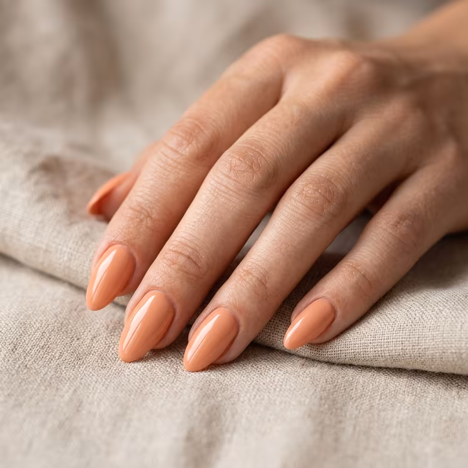 Mão com unhas pintadas com o Esmalte em Gel Canela, da Linha Essência Natural
